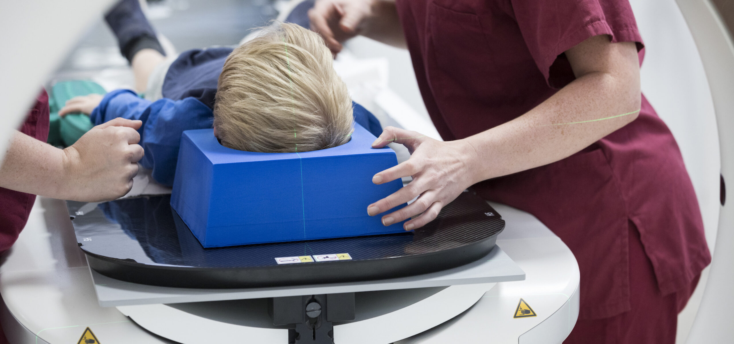 Cover photo for BRAINatomy, showing a child undergoing radiotherapy